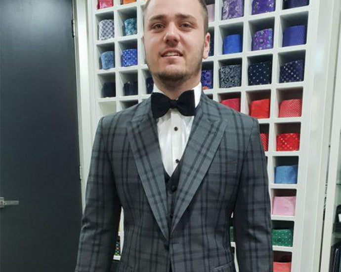 Regan finally picking up his bespoke suit.